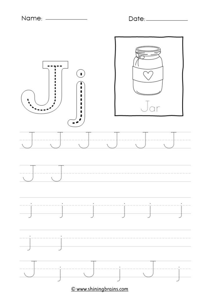 A close up of a childs hand tracing a letter J with a blue crayon