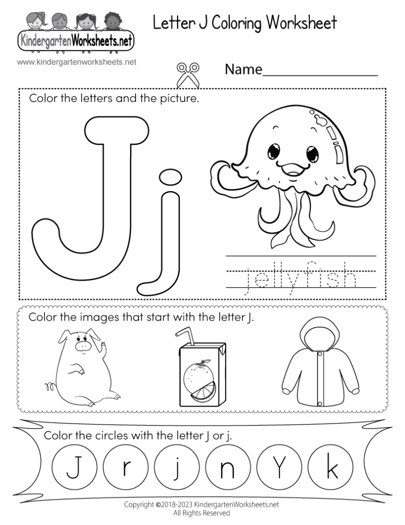 Preschooler practicing writing the letter J in a tray of colored sand