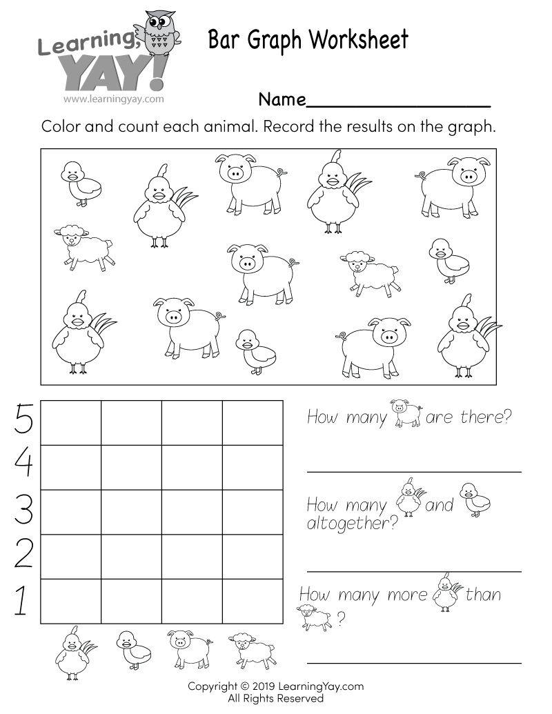 Close up of a young student's hand using a pencil on a math worksheet