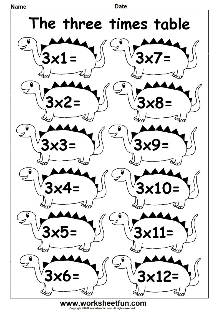 A child smiling while showing off a completed math page