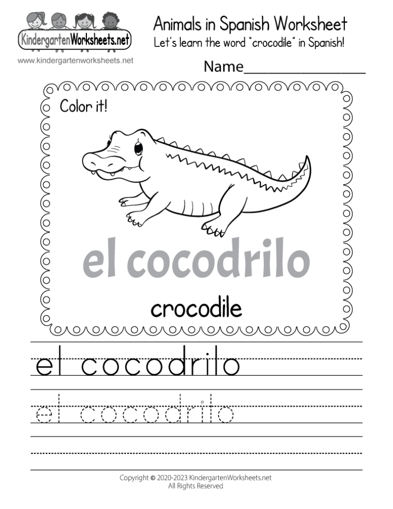 Close up of a student hand using a crayon to color a Spanish worksheet